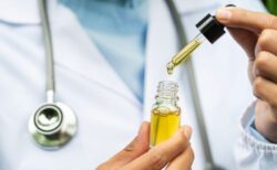 Doctor holding vial of CBD oil