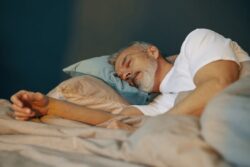 Senior man sleeping peacefully in his bed