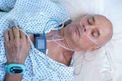 Man wearing sleep test equipment in laboratory setting 