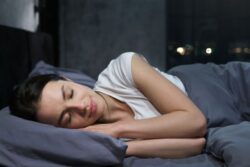Woman sleeping peacefully in comfy bed 