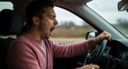 Man yawning while driving 